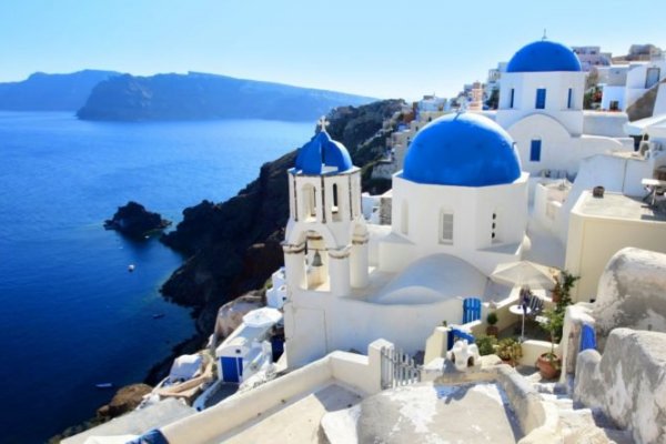 White-washed houses and blue domes on a Greek island